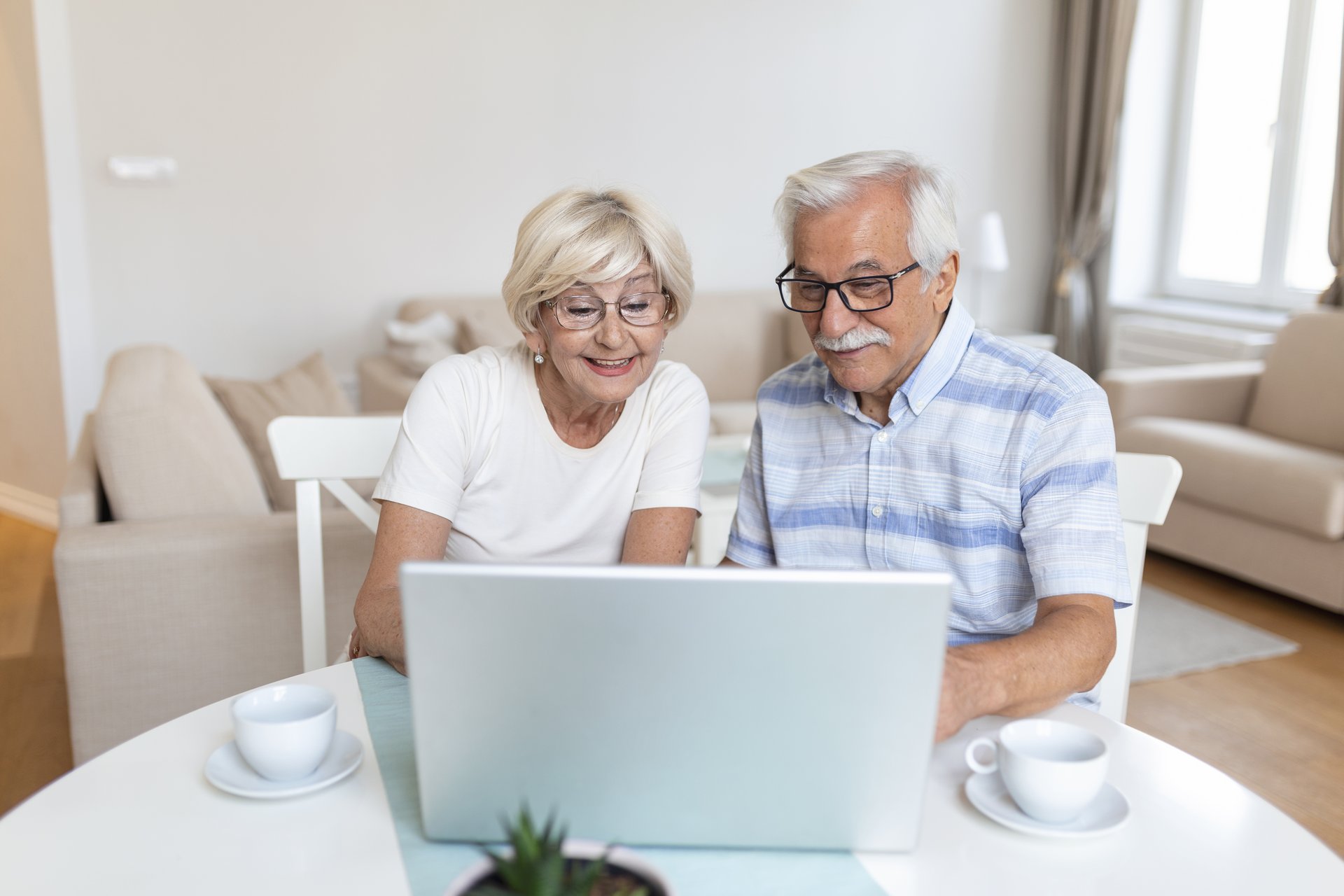 Senior couple is talking online via video connection on the laptop. Having nice time withfriends and family via video call. Senior couple is talking online via video connection on the laptop. Having nice time withfriends and family via video call.